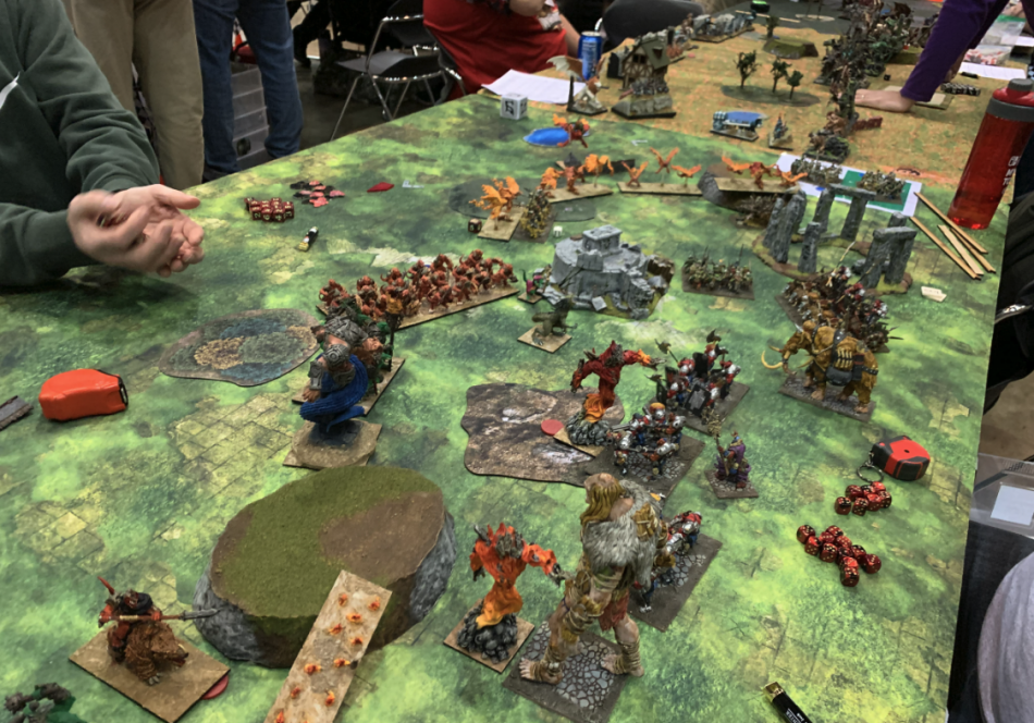 two fantasy armies clash on a game table