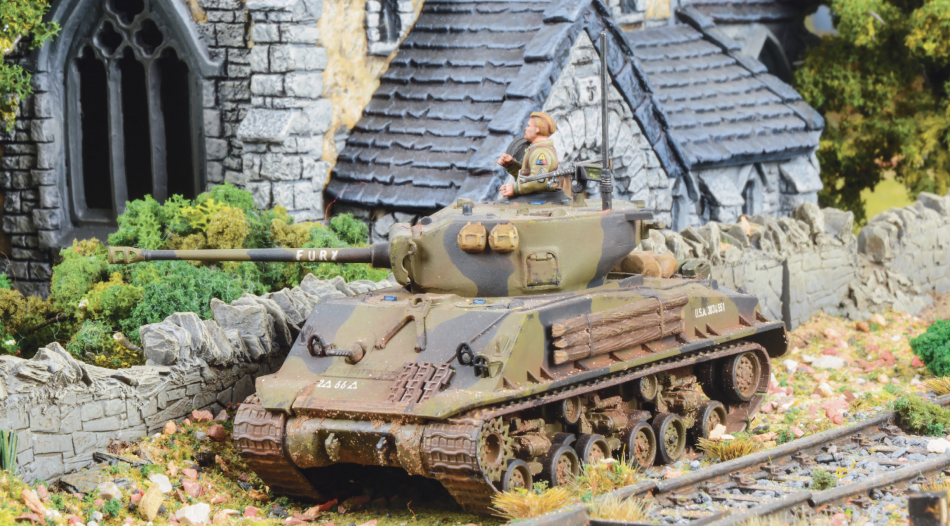 A model of a British Sherman tank rolls along a road