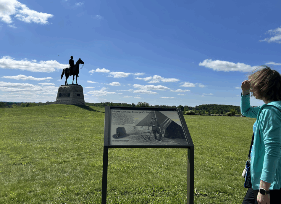 Woman looking at statue of General Meade at Gettysburg