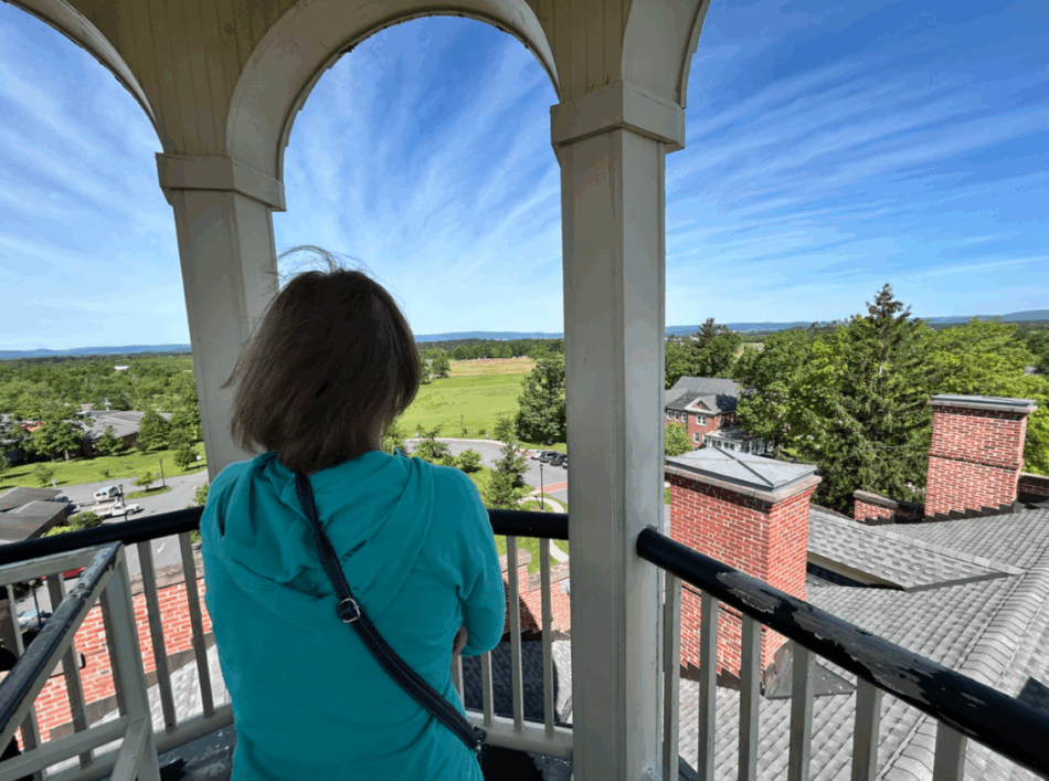 A woman standing in the Seminary Cupola surveys the view of the Day 1 Battlefield