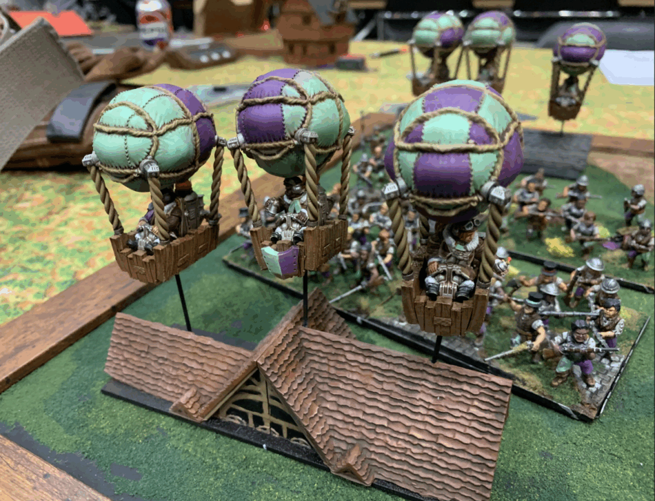 image of halflings in hot air balloons soaring aloft on a game table.